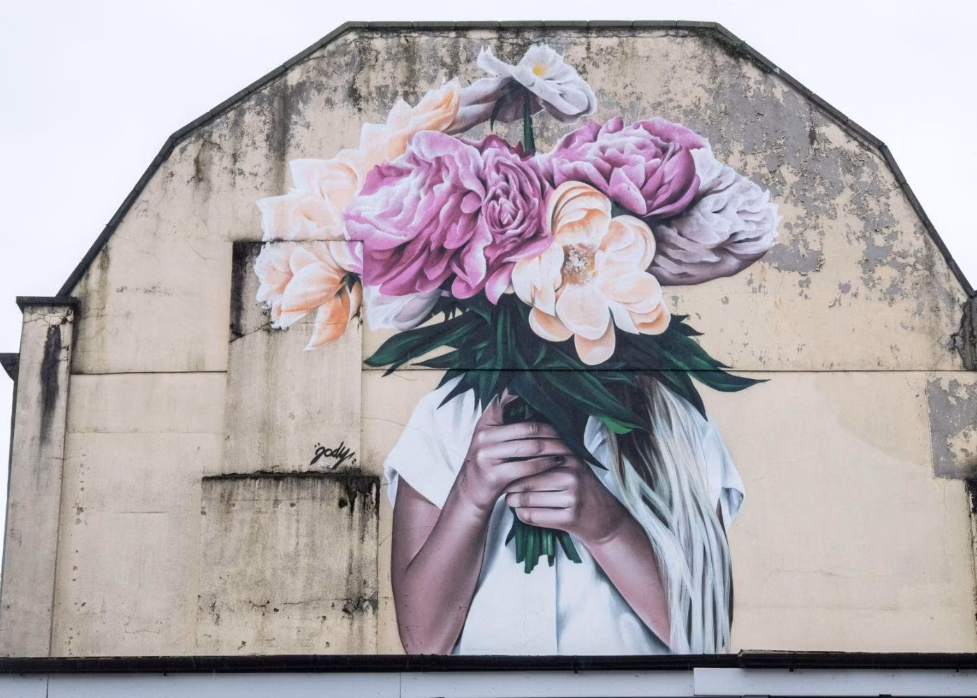 A Wall Painting in Redfield With a Mural of a Woman Holding Flowers