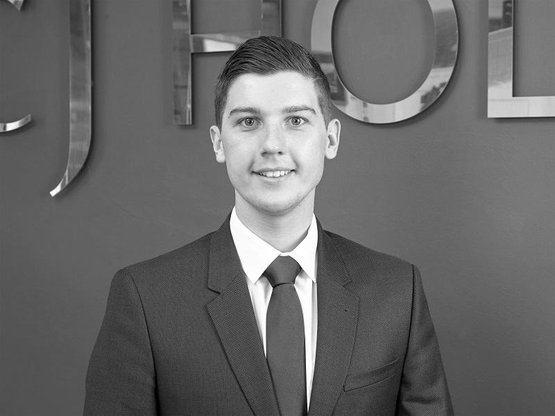 A property consultant posing inside the CJ Hole Long Ashton estate agent office.