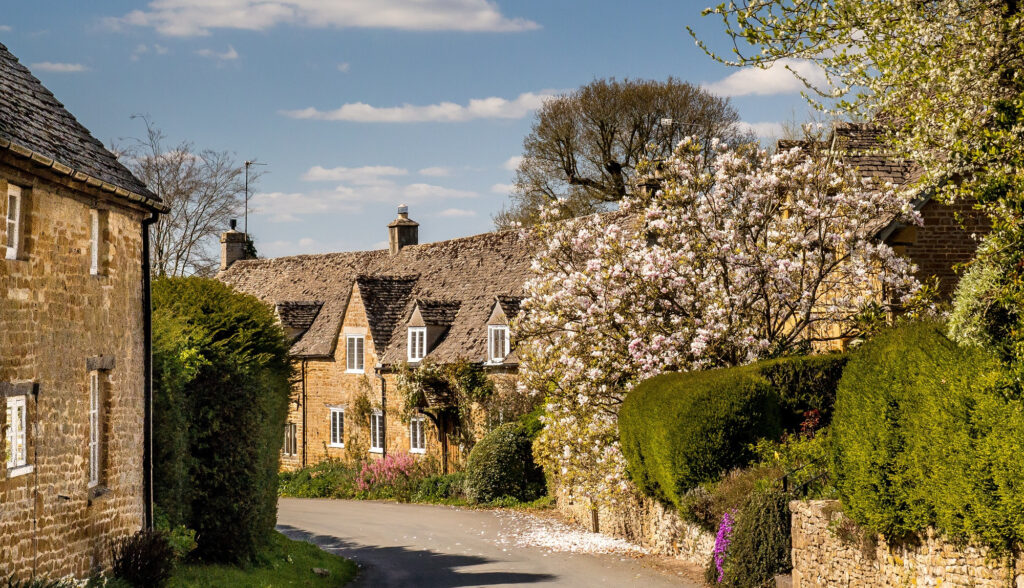 A serene country road winding through the picturesque Cotswolds.
