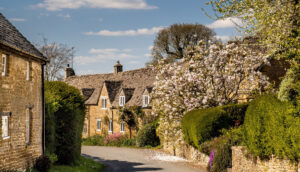 A serene country road winding through the picturesque Cotswolds.