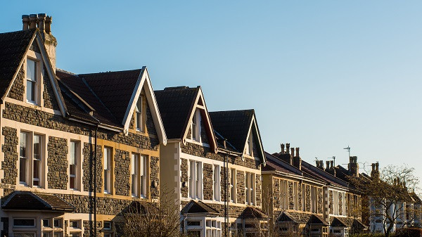 Terraced houses basking in sunlight on a clear day.