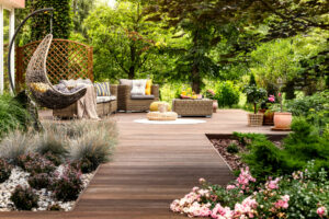 a garden with a wooden walkway and a wooden bench