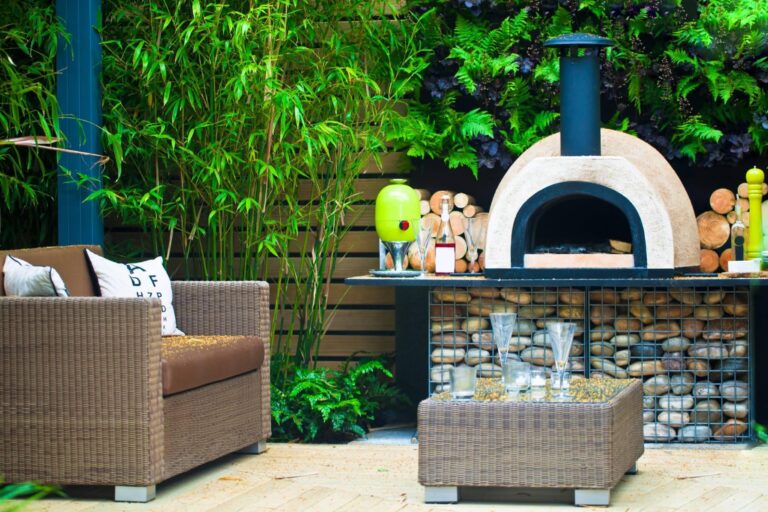 Patio featuring a pizza oven beside a dining table.