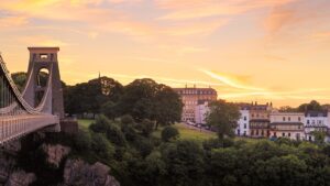 Clifton Suspension Bridge in Bristol, England, illuminated at sunset.