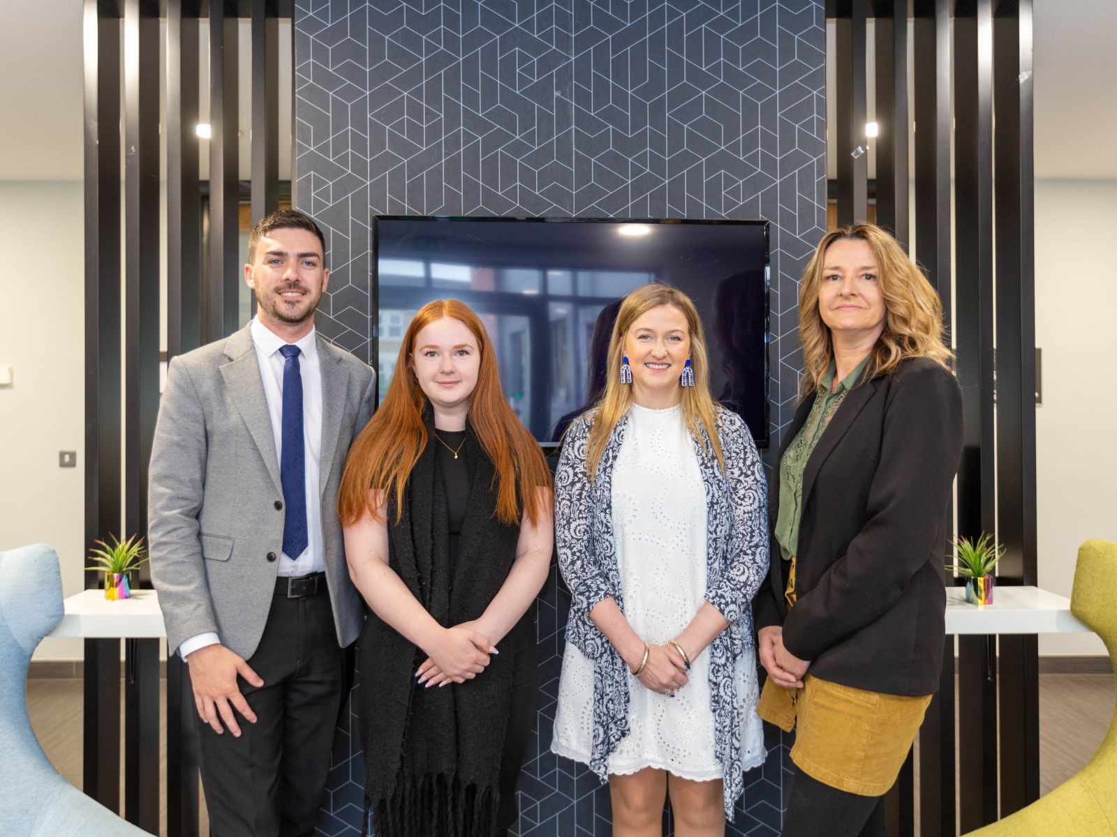 A group of estate agents posing inside the CJ Hole Burnham-on-Sea letting office.