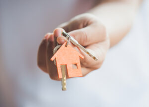 a woman holding a house key in her hand