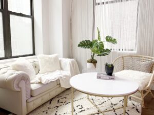 Living room featuring white furniture and a stylish rug, presented in welcoming setup for home valuation