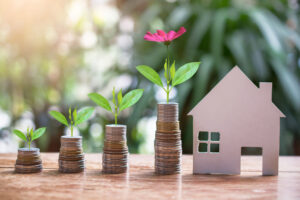 a house and coins on a table