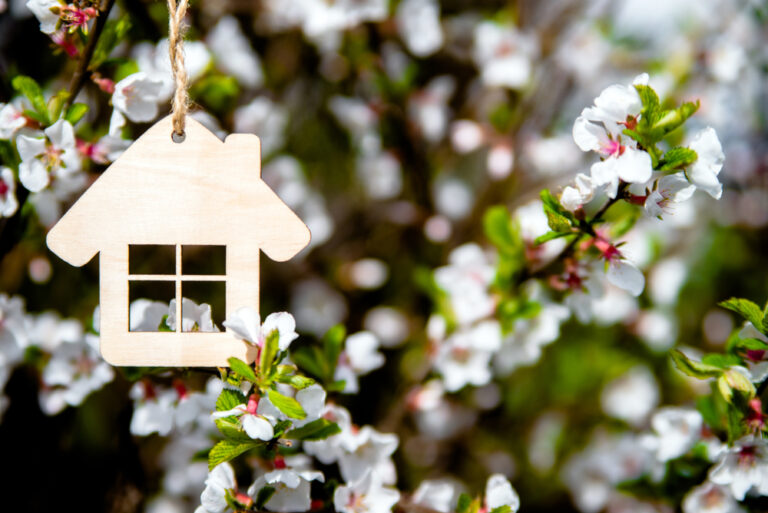 a wooden birdhouse hanging on a tree branch
