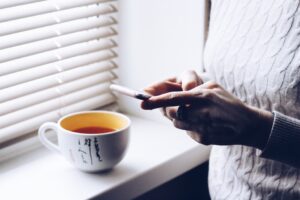 Woman using a smartphone to check online house valuation
