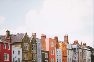 A row of vibrant, colourful buildings under a clear blue sky.
