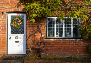 a brick house with a white door and window
