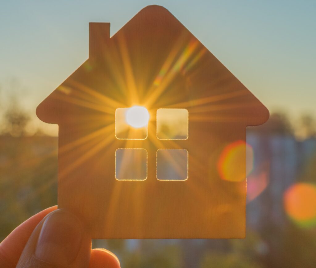 a person holding a house in their hand