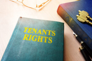 Tenants' rights book with a pen and glasses on a table.