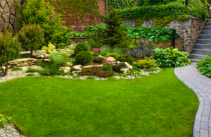 a garden with a stone path and a stone wall
