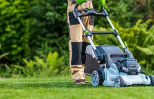 a man mowing a lawn with a lawn mower