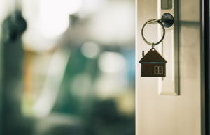 a door handle with a house shaped key