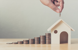 a person putting coins in a house